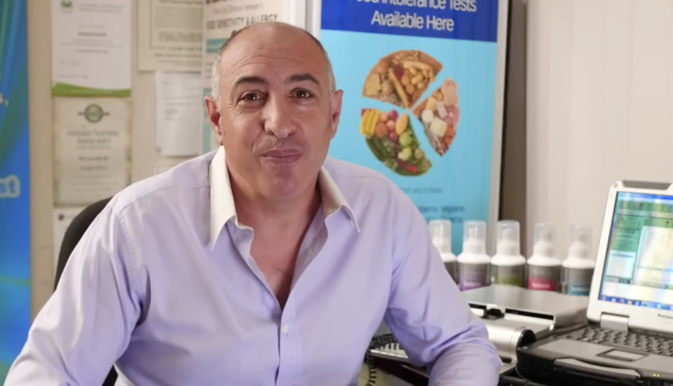 Douglas Mizzi reviewing digestive and dietary patterns with a client
